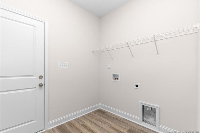 washroom featuring hookup for a washing machine, hardwood / wood-style flooring, and electric dryer hookup