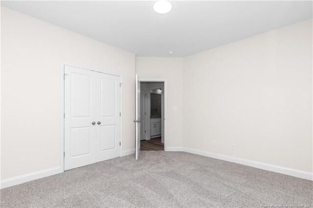 unfurnished bedroom featuring a closet and carpet floors