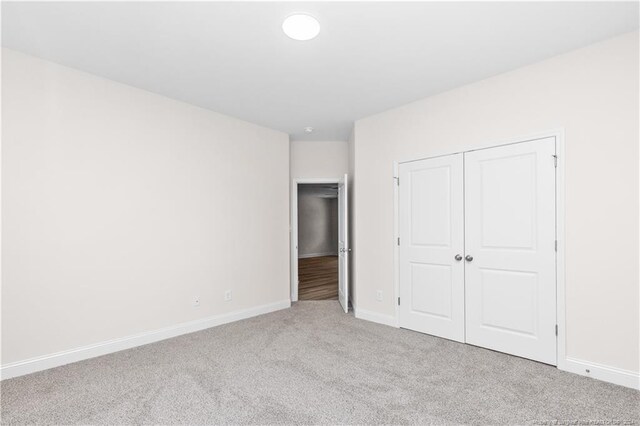 unfurnished bedroom with a closet and carpet floors