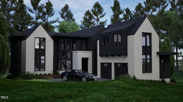 view of front of home featuring a front yard, an attached garage, and brick siding