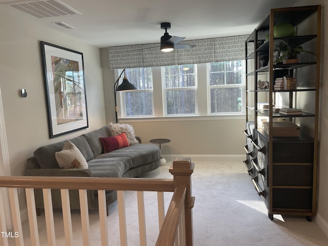 carpeted living room with ceiling fan