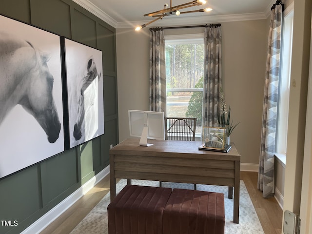 office space featuring ornamental molding and light hardwood / wood-style flooring