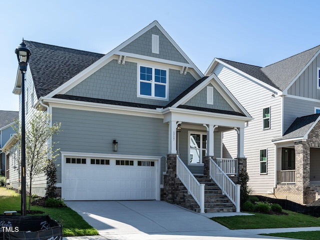 craftsman inspired home featuring a garage and covered porch