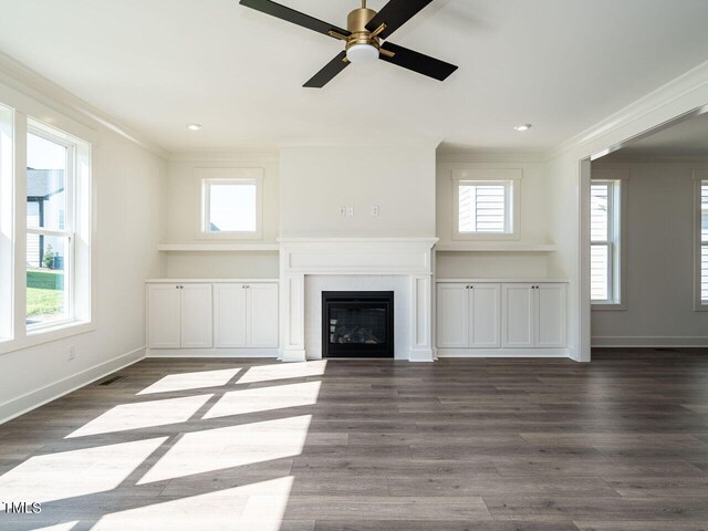 unfurnished living room with hardwood / wood-style flooring, crown molding, and ceiling fan