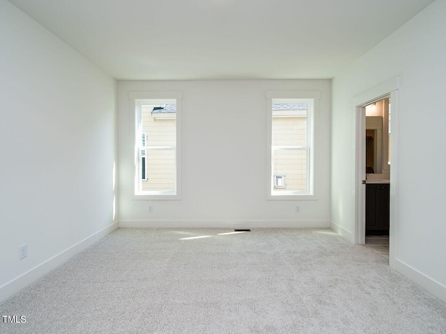 carpeted spare room with plenty of natural light