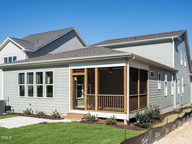 view of front of property with a front lawn, central air condition unit, and a sunroom