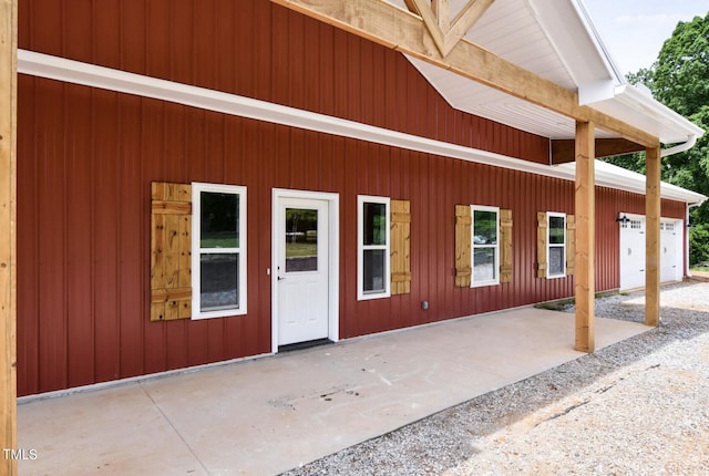 view of exterior entry featuring a patio