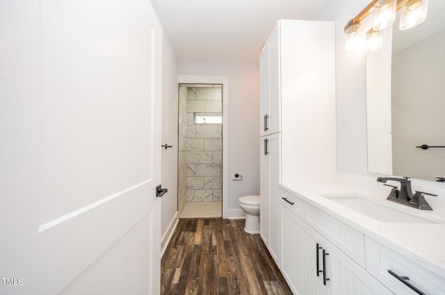 bathroom with hardwood / wood-style flooring, toilet, and large vanity