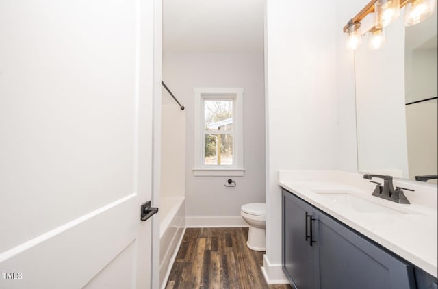 full bathroom with hardwood / wood-style flooring, toilet, vanity, and shower / bath combination