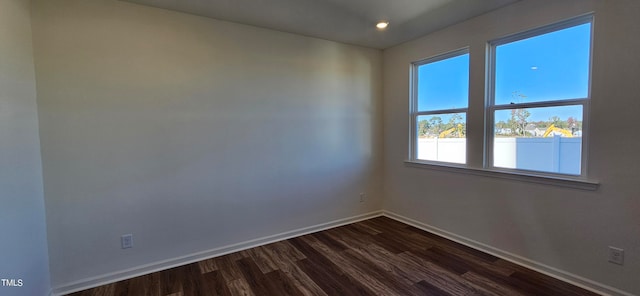 empty room with dark wood-type flooring