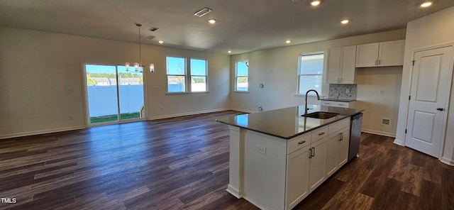 kitchen with dishwasher, dark hardwood / wood-style floors, a center island with sink, white cabinetry, and sink