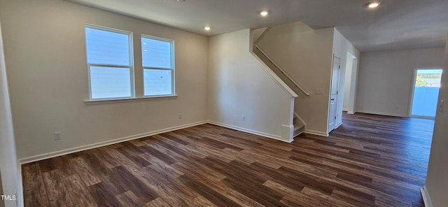 interior space featuring plenty of natural light and dark hardwood / wood-style floors