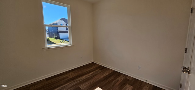 unfurnished room featuring dark wood-type flooring