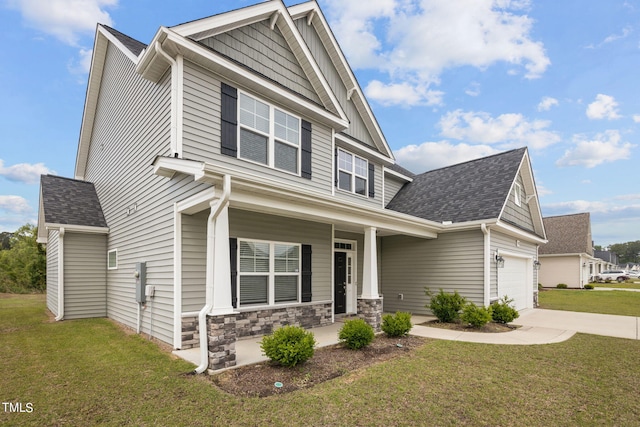 craftsman inspired home with covered porch, a garage, and a front lawn