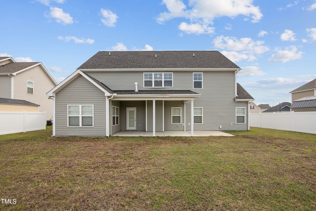 rear view of house featuring a patio and a lawn