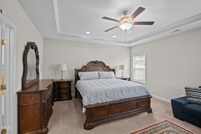 carpeted bedroom featuring ceiling fan and a raised ceiling