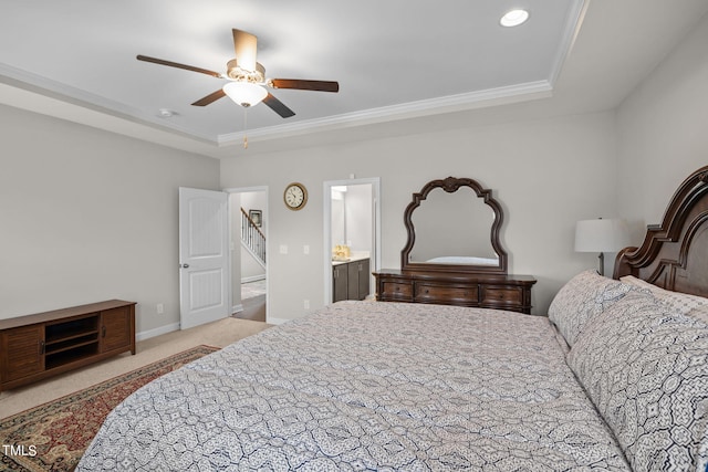 carpeted bedroom featuring ornamental molding, connected bathroom, a raised ceiling, and ceiling fan