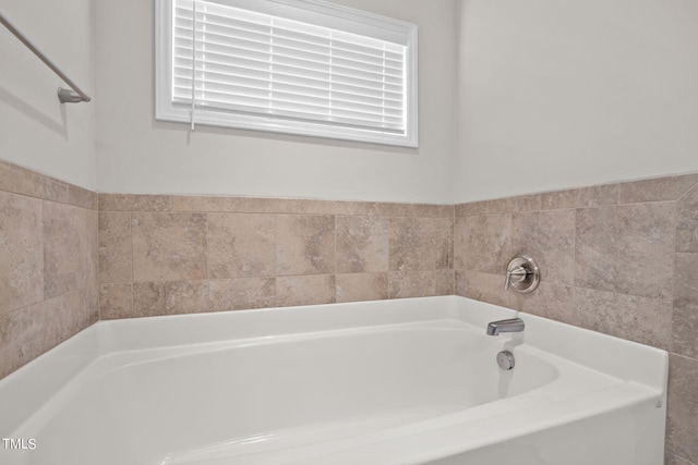 bathroom featuring a bath to relax in