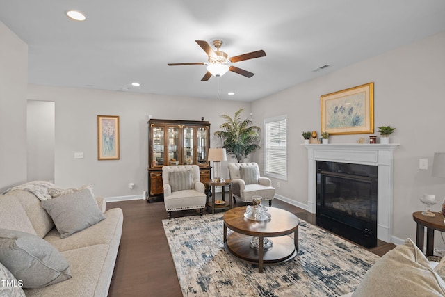 living room with dark hardwood / wood-style floors and ceiling fan