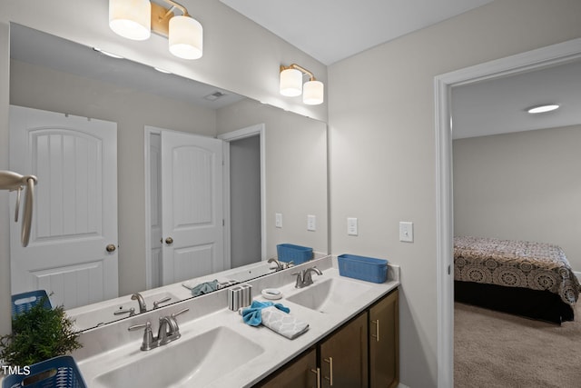 bathroom with dual sinks and vanity with extensive cabinet space