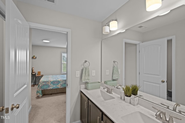 bathroom with dual sinks and vanity with extensive cabinet space