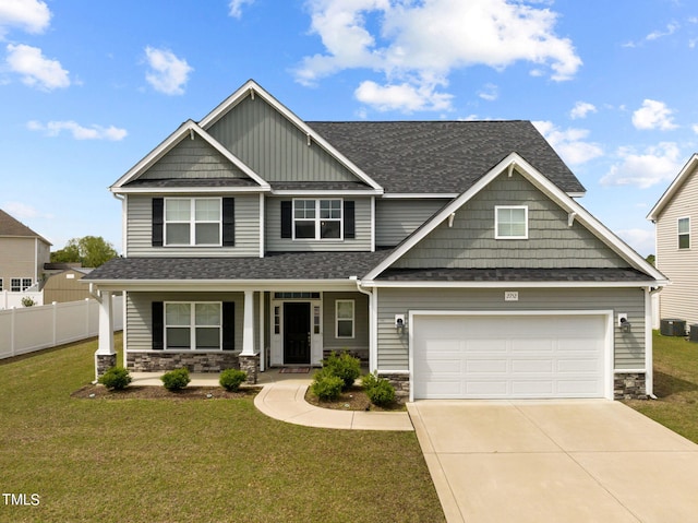 craftsman-style home featuring central AC, a front lawn, a garage, and a porch