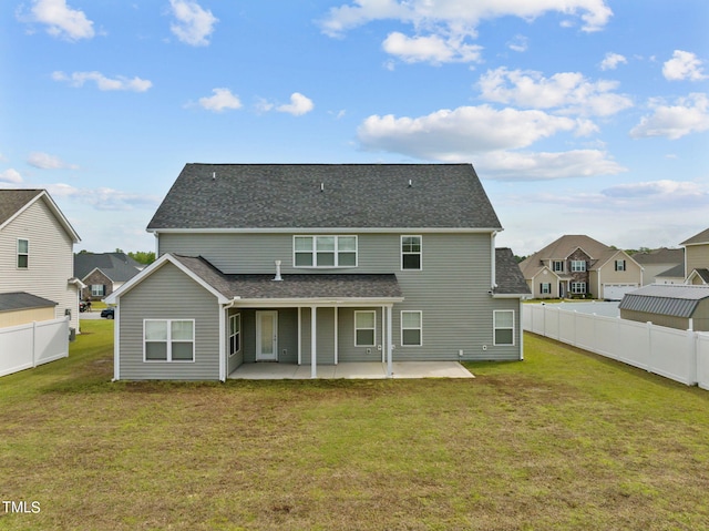 back of property with a yard and a patio area