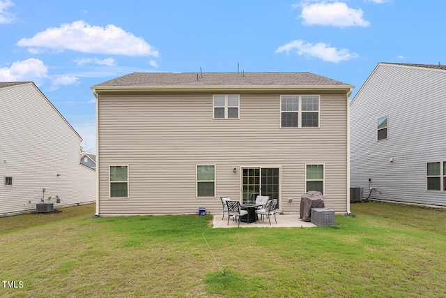 back of house with central air condition unit, a patio area, and a yard