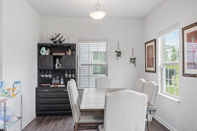 dining area featuring a healthy amount of sunlight and dark wood-type flooring