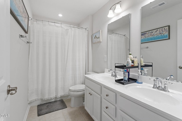 bathroom featuring vanity, toilet, tile patterned floors, and walk in shower