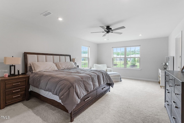 bedroom featuring light colored carpet and ceiling fan