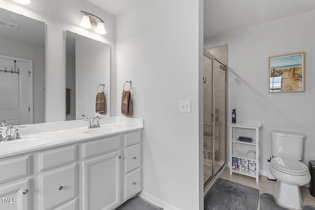 bathroom featuring vanity, toilet, tile patterned floors, and walk in shower