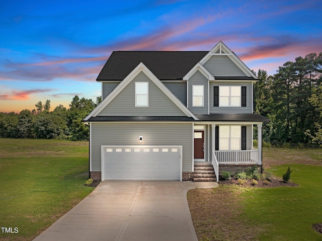 view of front of home with a yard, covered porch, and driveway