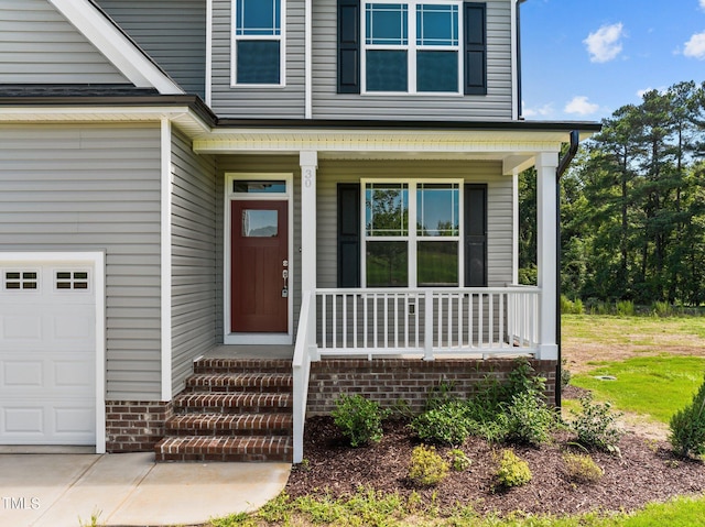 doorway to property featuring a garage and covered porch