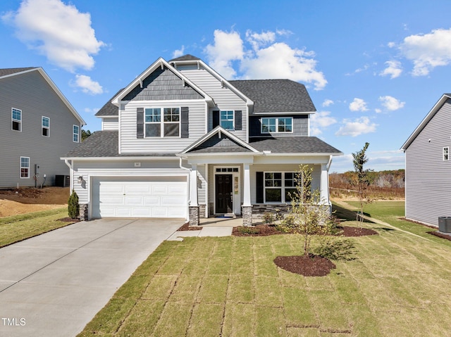 craftsman-style house featuring a front yard, a garage, and a porch