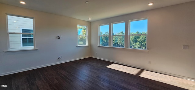 spare room with dark hardwood / wood-style floors