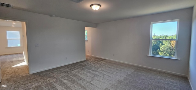 unfurnished room featuring carpet