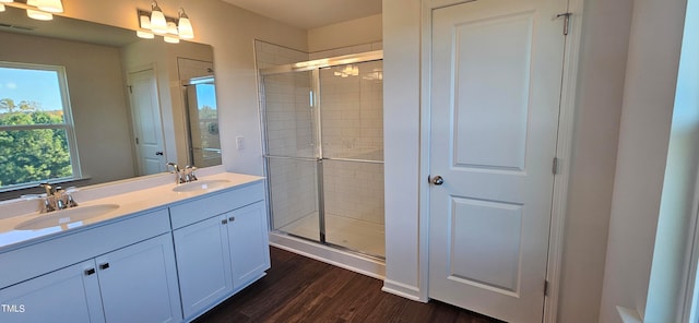 bathroom featuring wood-type flooring, vanity, and walk in shower