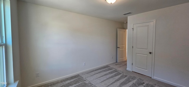 empty room featuring light colored carpet