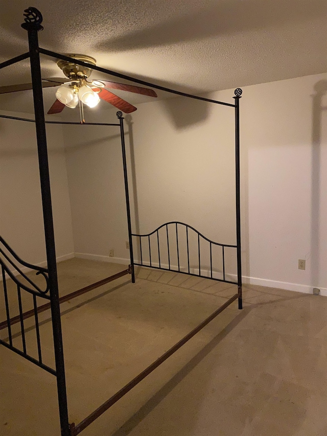 unfurnished bedroom with a textured ceiling and ceiling fan