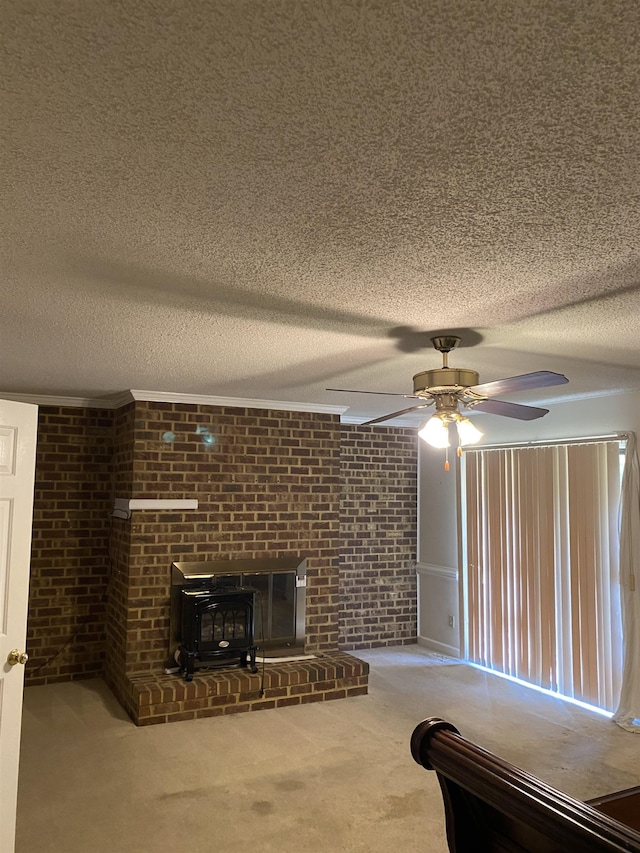 interior space featuring ceiling fan, a fireplace, carpet flooring, a textured ceiling, and a wood stove