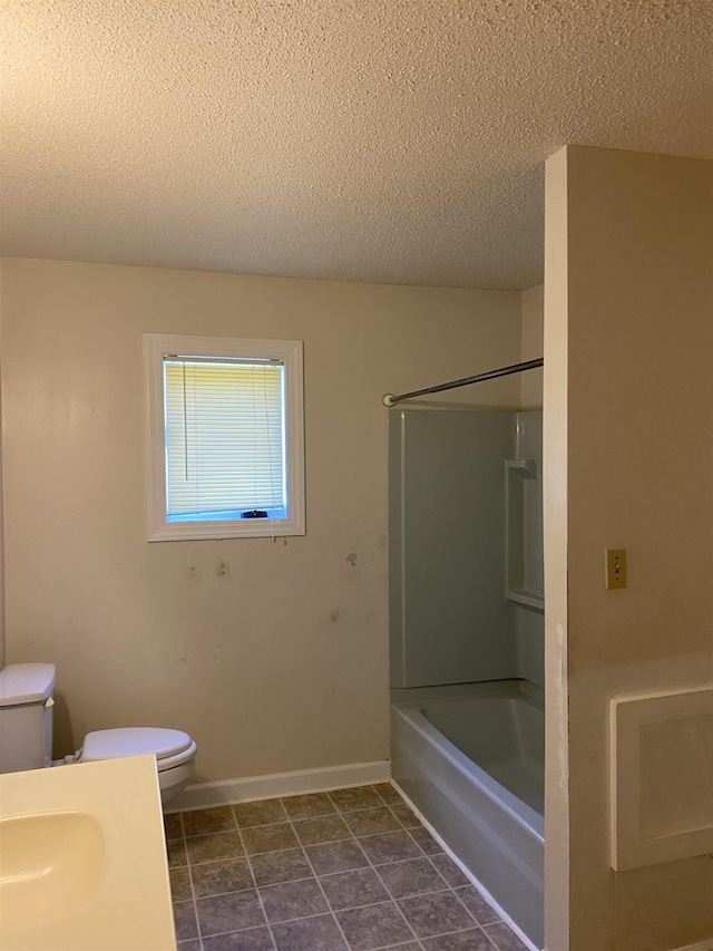 full bathroom with tile flooring, shower / washtub combination, toilet, and a textured ceiling