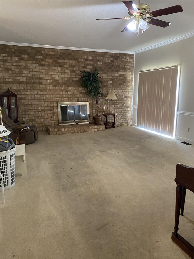 unfurnished living room featuring carpet, ceiling fan, ornamental molding, and brick wall