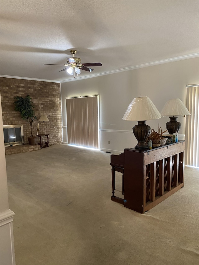 interior space with crown molding, a textured ceiling, brick wall, and ceiling fan