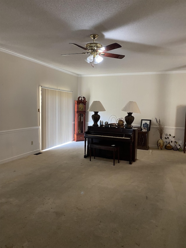 carpeted bedroom featuring a textured ceiling, ornamental molding, and ceiling fan