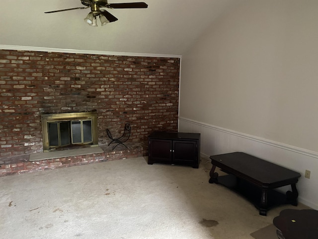 unfurnished living room featuring brick wall, ceiling fan, carpet flooring, and a brick fireplace