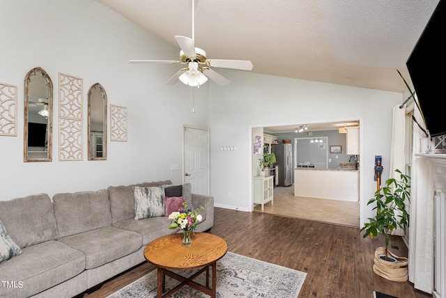 living room with sink, dark hardwood / wood-style floors, ceiling fan, and vaulted ceiling