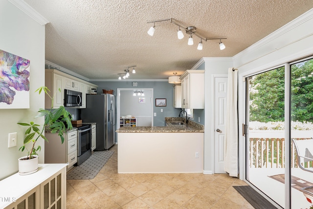 kitchen with sink, track lighting, light tile floors, and stainless steel appliances