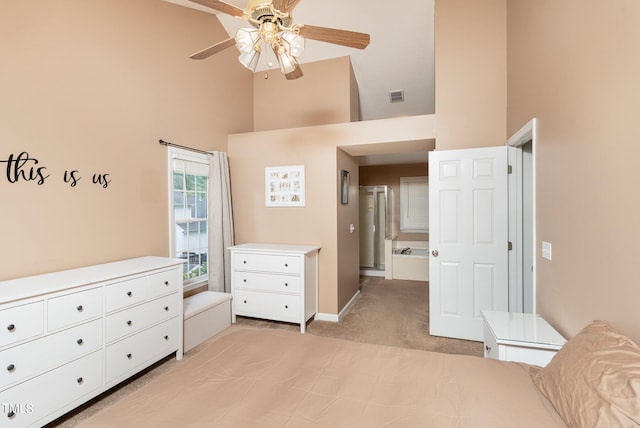 bedroom featuring light carpet, a high ceiling, and ceiling fan