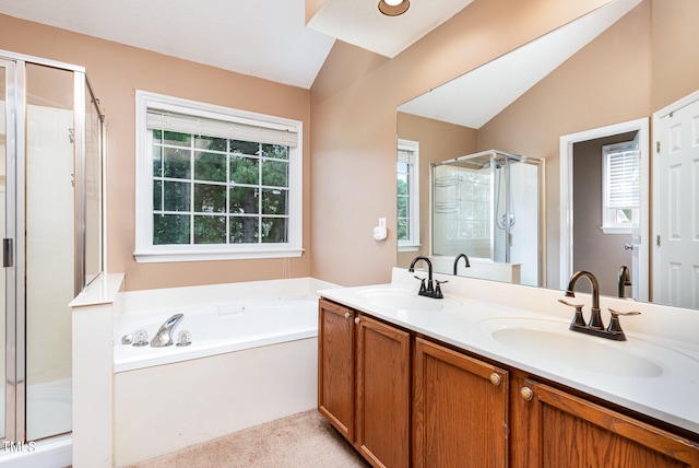 bathroom featuring a healthy amount of sunlight, double vanity, vaulted ceiling, and plus walk in shower